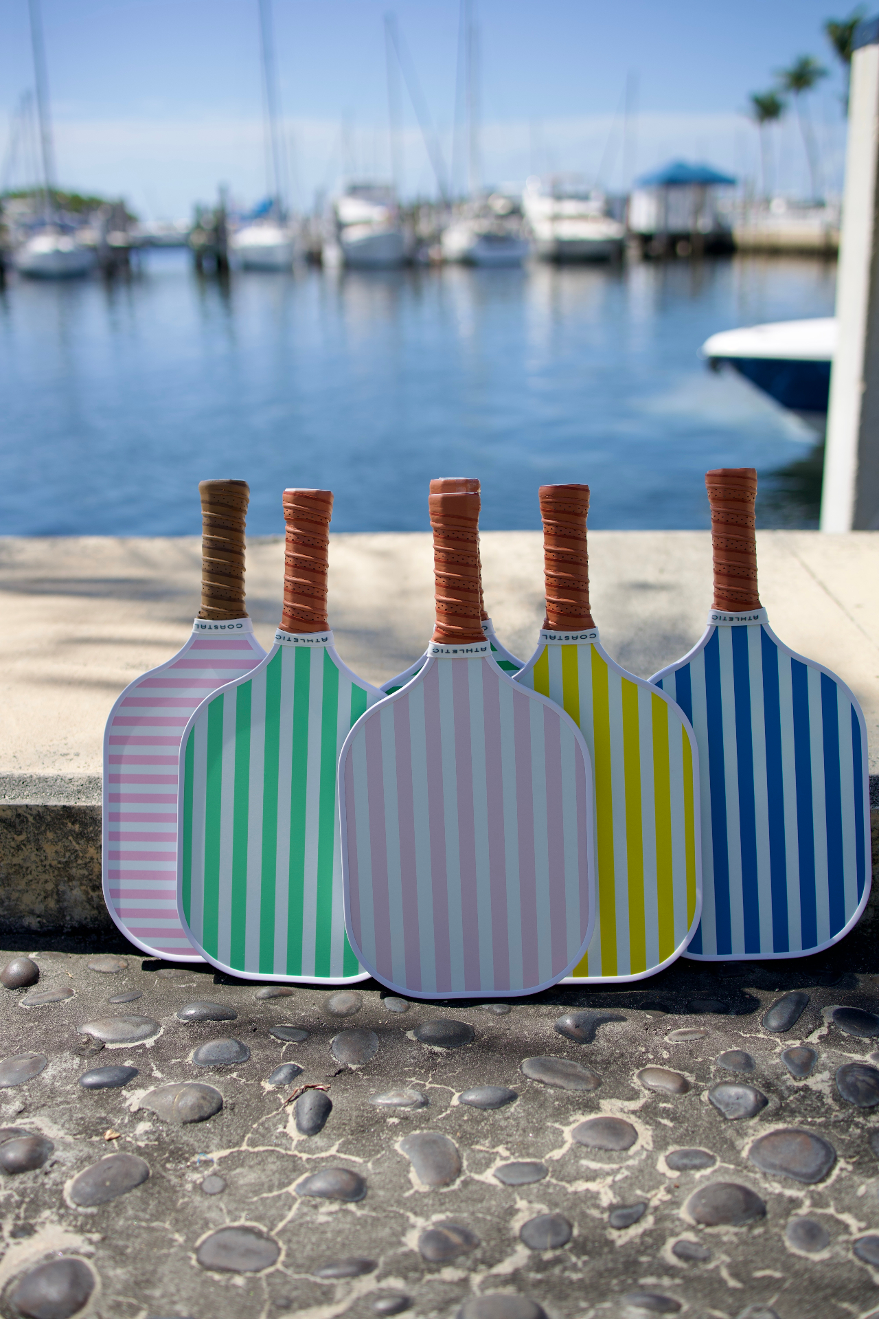 Coastal Athletic paddles on the seawall at the marina